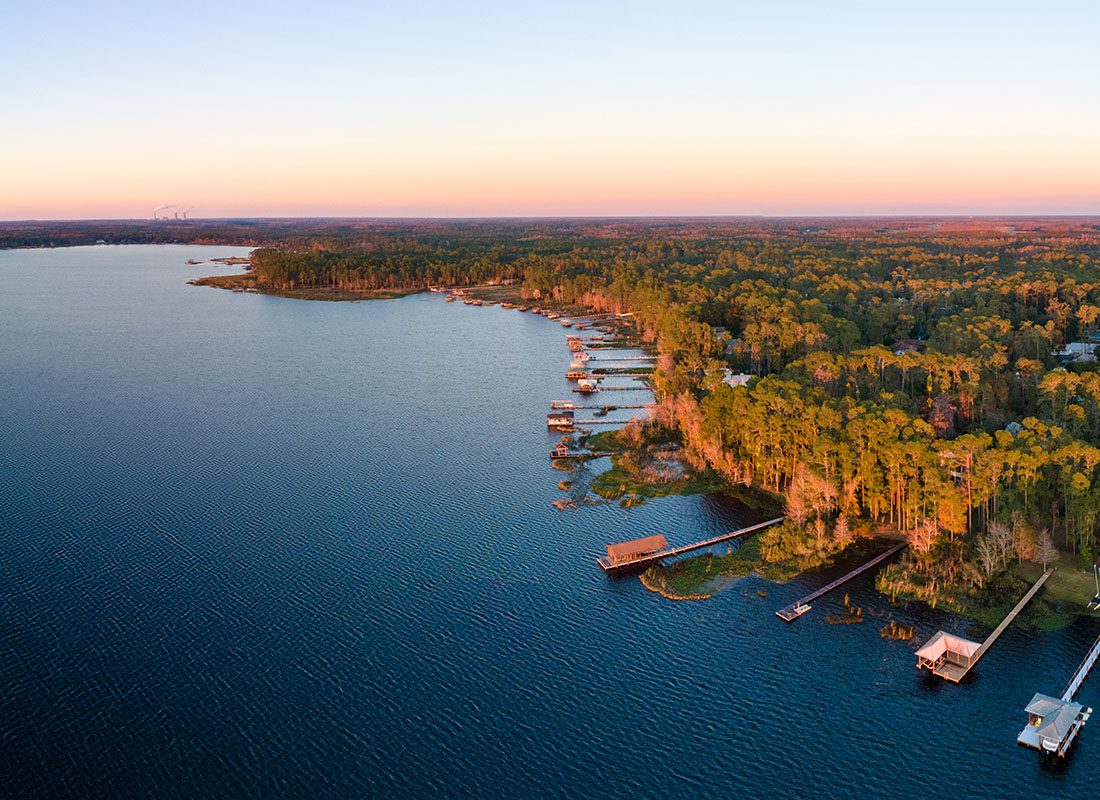 Lake Mary, FL - Aerial View of a Deep Blue lake with Homes and Docks by the Water at Sunset in Lake Mary Florida